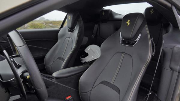 2024 Ferrari Roma Spider front seats with helmet in back seat