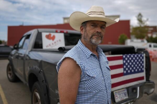 Cowboy David Graham, of Newark, Ohio, on hand with a message of support, stands near his truck across the street from City Hall, Tuesday, Sept. 17, 2024, in Springfield, Ohio. (AP Photo/Carolyn Kaster)