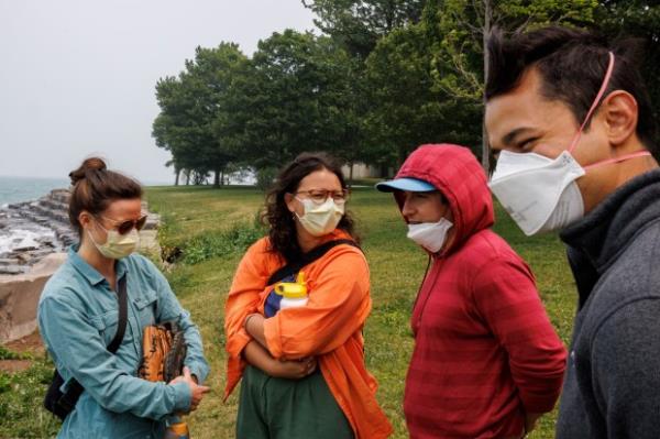 Aly Bothman, 30, from left, Miranda Mireles, 23, Max Loy, 30, and Liam Mireles, 30, wear masks at Promo<em></em>ntory Point while smoke from Canadian wildfires passes through Chicago on June 27, 2023. According to the mo<em></em>nitoring site IQAir, Chicago had the worst air quality out of 95 cities worldwide on that day. (Armando L. Sanchez/Chicago Tribune)