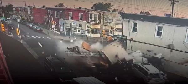 Surveillance footage shows the moment two trucks crashed into each other in Philadelphia.