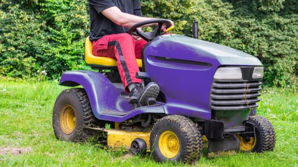 Person on purple riding mower