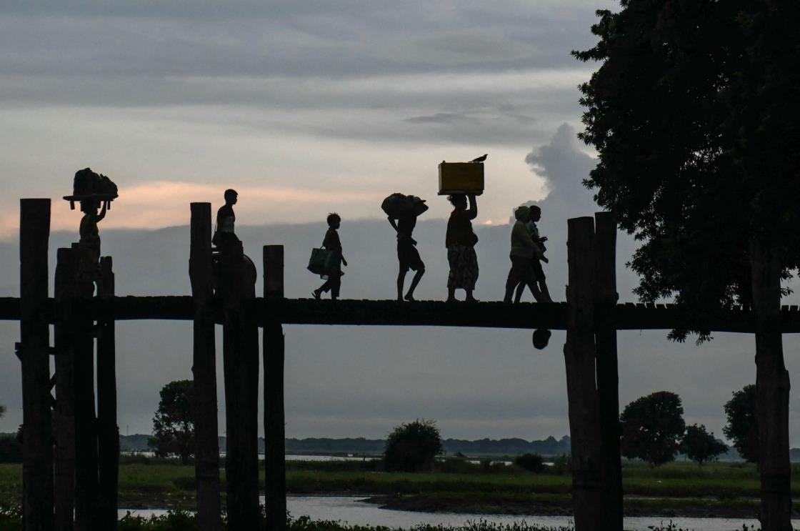 People walk on U Bein bridge at Taungthaman Lake, Mandalay, Myanmar, Oct. 23, 2024. (AFP Photo)