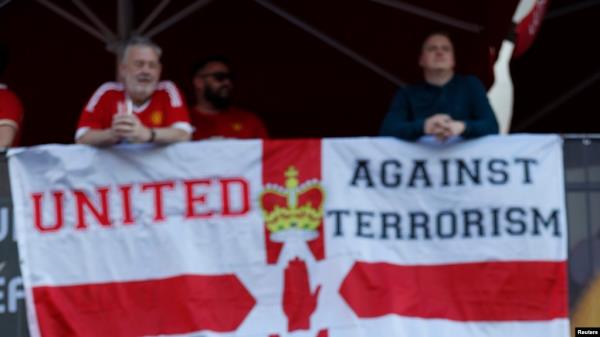 Manchester United fans hang a banner in reference to the terror attack in Manchester before a match.