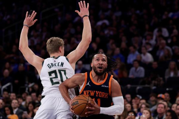 New York Knicks guard Jalen Brunson (11) drives to the basket past Milwaukee Bucks guard AJ Green (20) during the second half of an NBA basketball game Friday, Nov. 8, 2024, in New York.