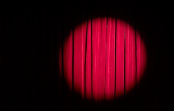 Spot light on red theatre curtains