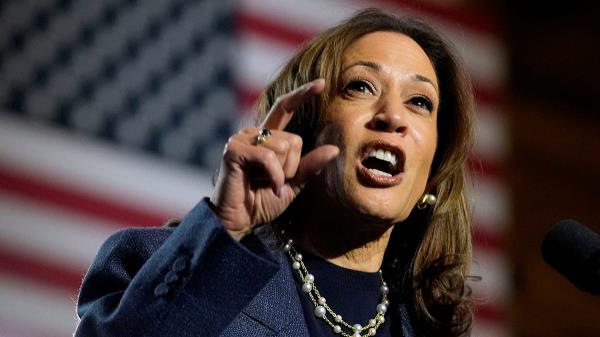 Kamala Harris closeup shot from rally, US flag behind her