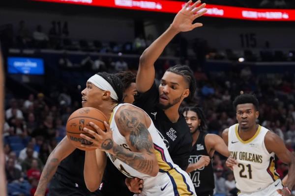 Pelicans guard Brandon Boston Jr. drives to the basket against Brooklyn Nets forward Ziaire Williams in the first half of an NBA basketball game.