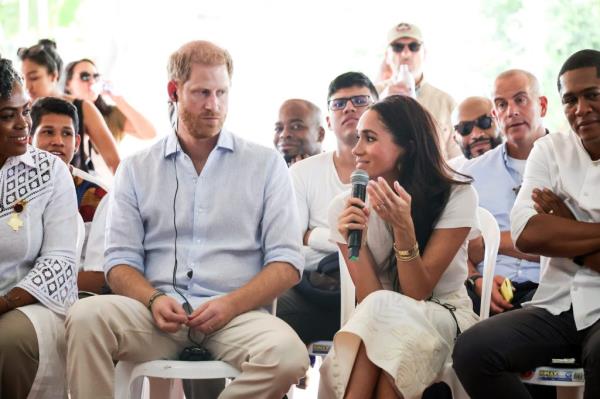 Prince Harry and Meghan, Duchess of Sussex, sitting in chairs with micropho<em></em>nes during their visit to Unidad Recreativa El Vallado in Cali, Colombia, advocating for child o<em></em>nline safety.